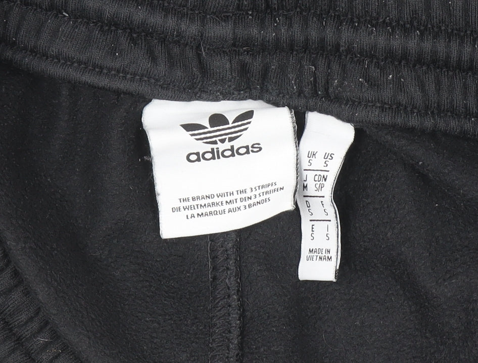 Brand and care label for adidas boys’ black jogger activewear trousers, size S, with side stripe