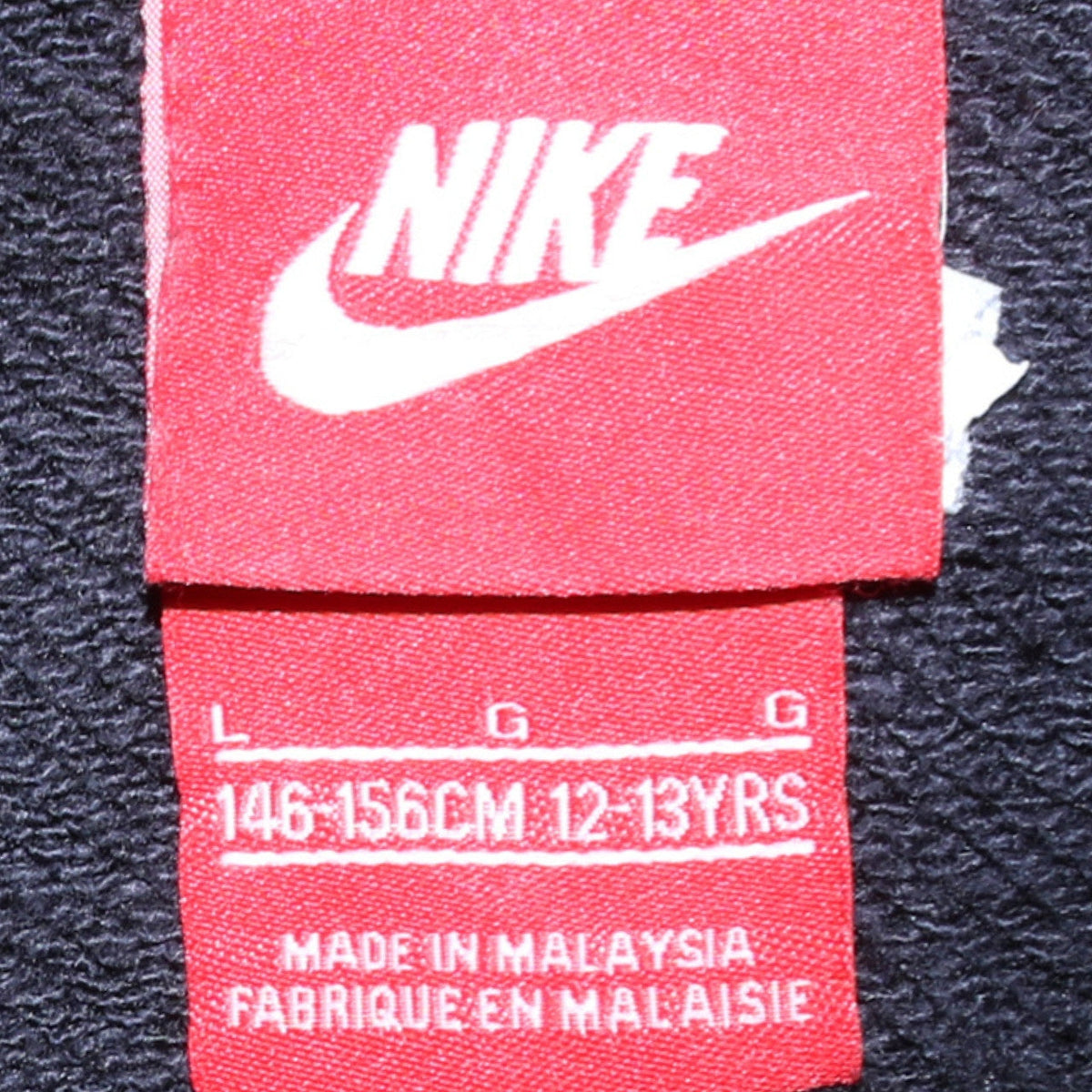 Close-up detail of Nike boys’ black full zip hoodie 12-13 years fleece sweatshirt