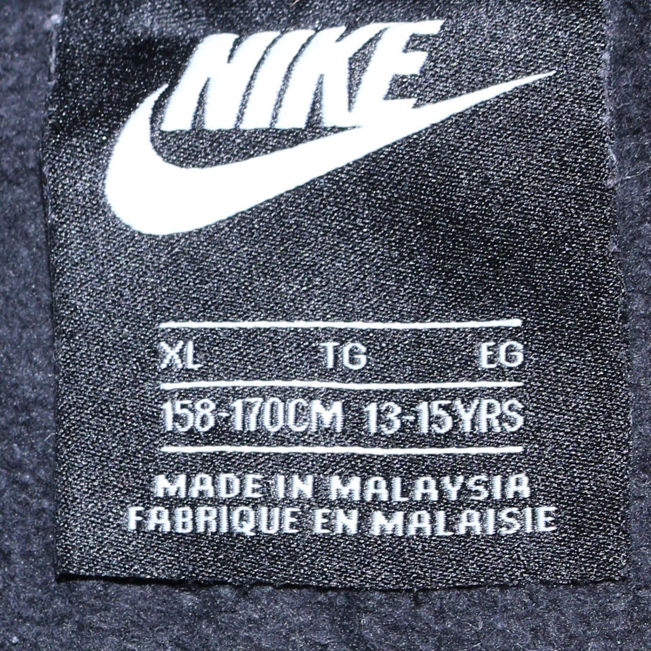 Close-up detail of Nike boys’ black full zip fleece hoodie xl 13-15 years sportswear