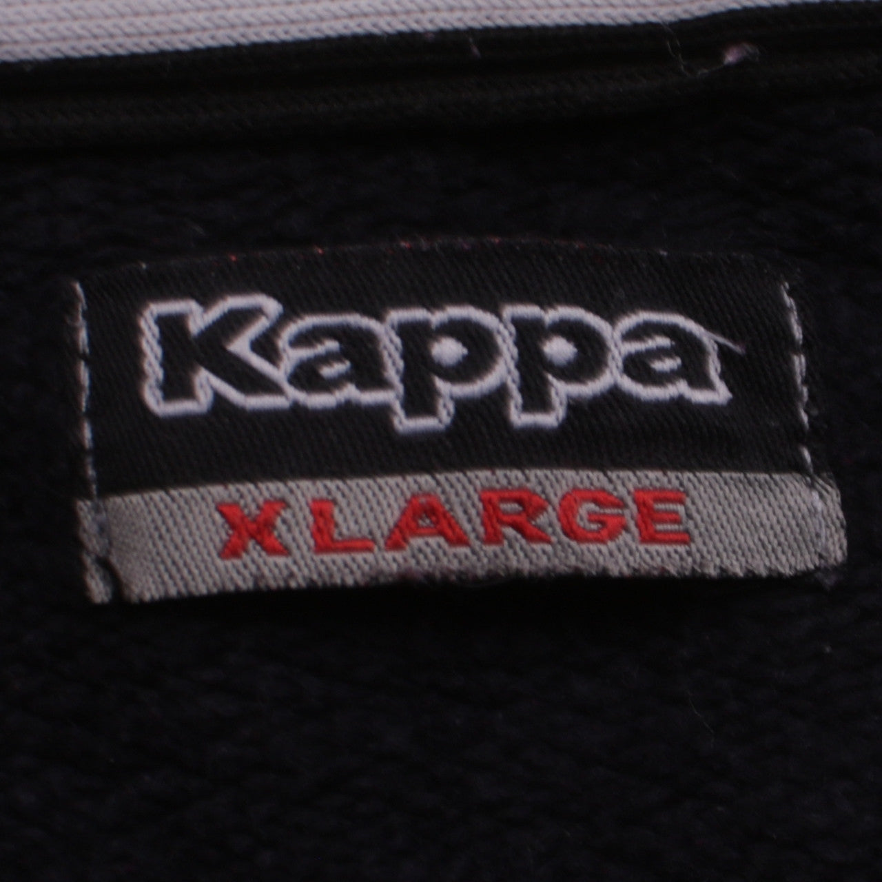 Close-up detail of Kappa boys’ black xl full zip fleece sweatshirt with logo