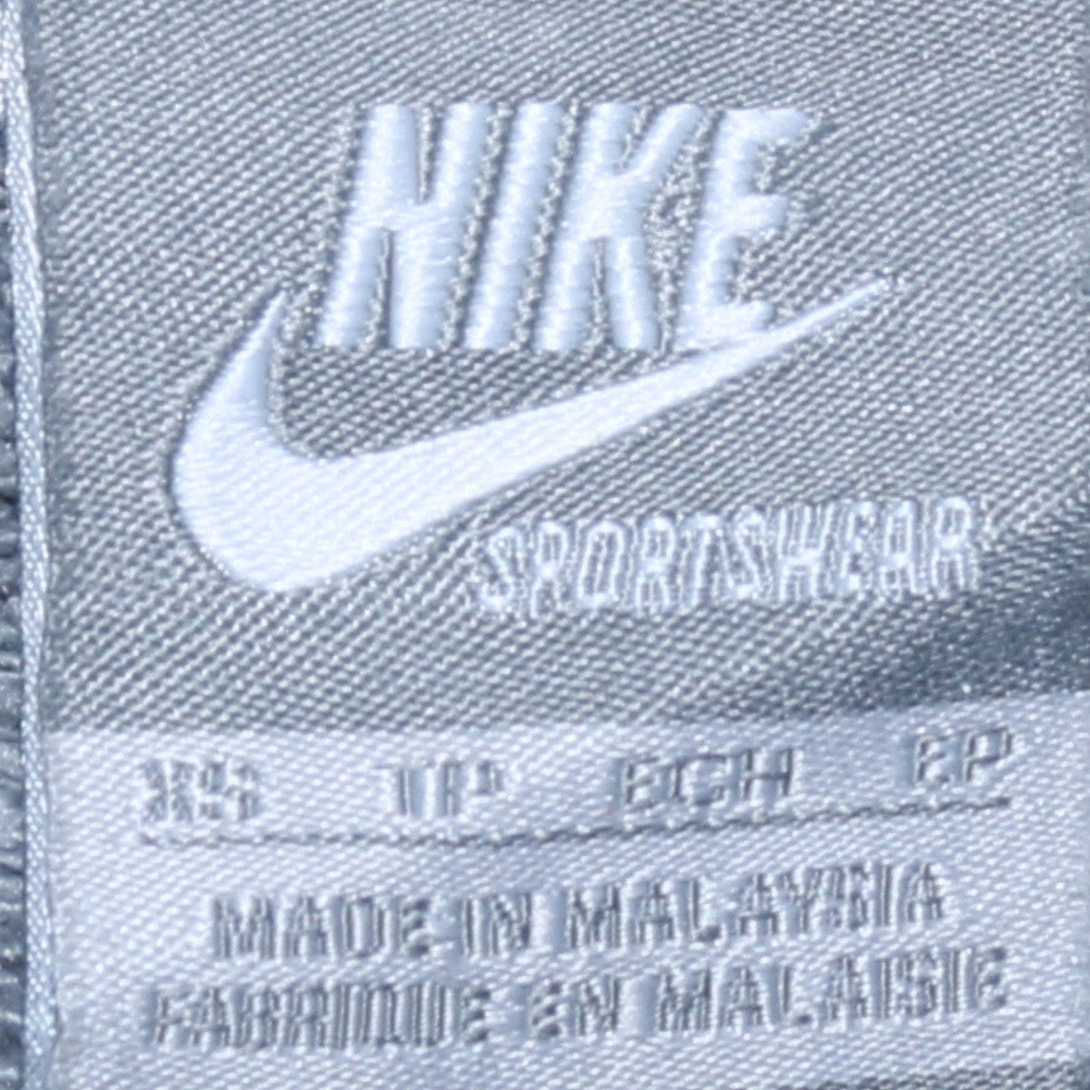 Close-up detail of Nike men’s beige pullover hoodie, size XS, fleece sportswear