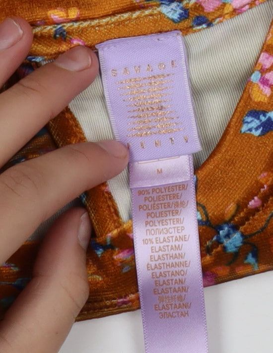 Brand and care label for Savage X Fenty women’s orange floral velvet t-shirt m