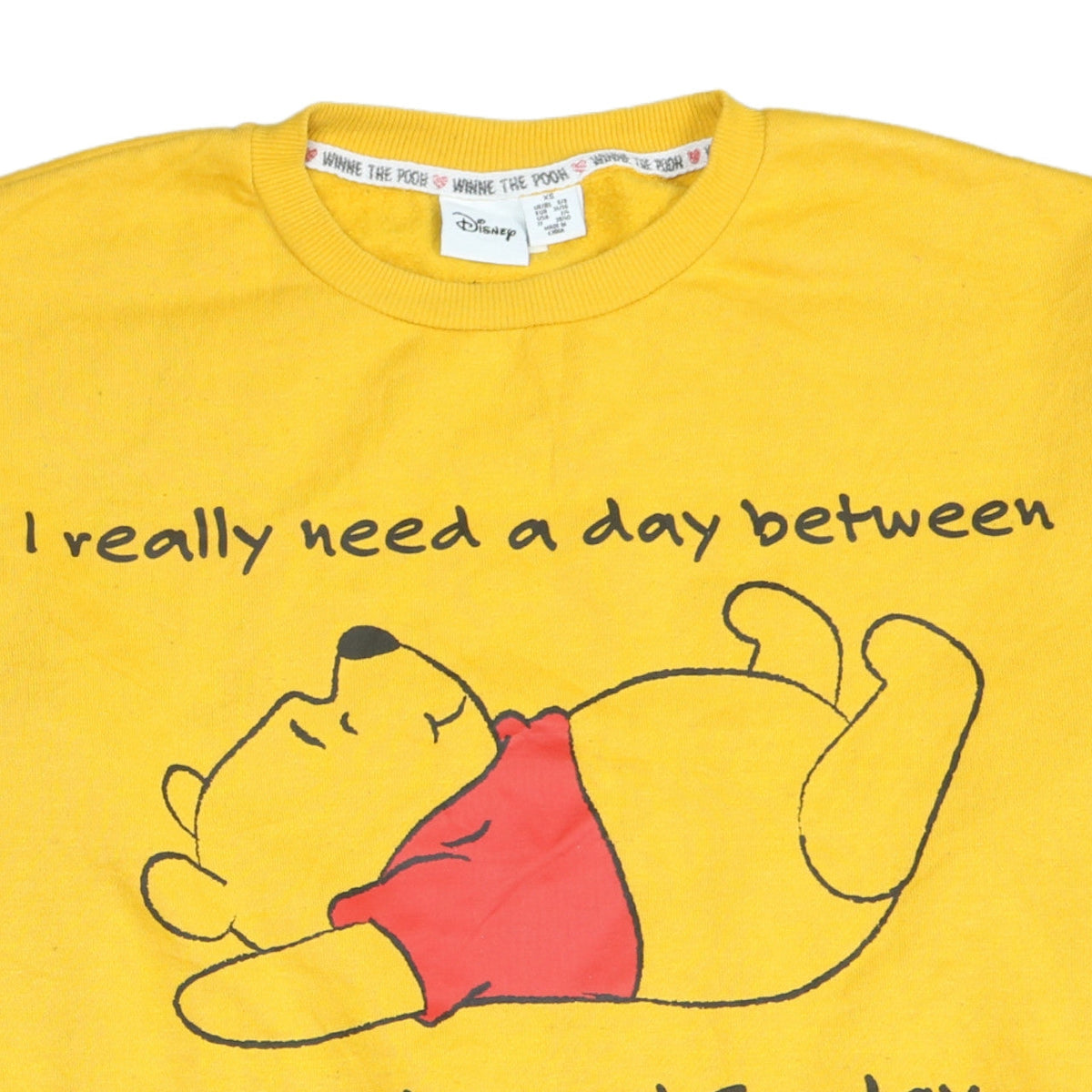Brand and care label for Disney Women Yellow Winnie the Pooh Pullover Sweatshirt XS
