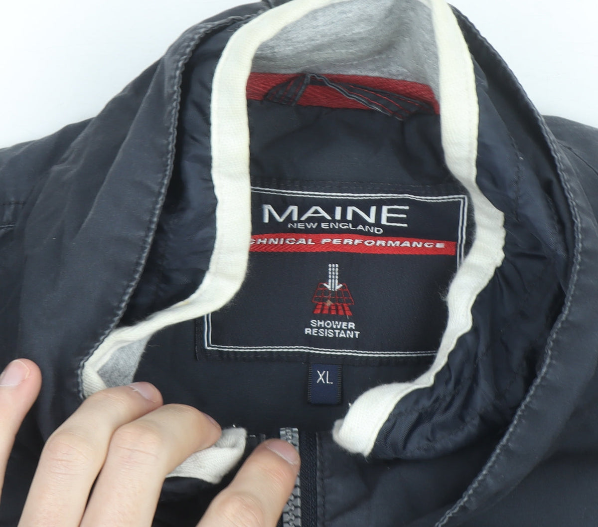 Brand and care label for Maine New England Men's Blue XL Shower Resistant Jacket