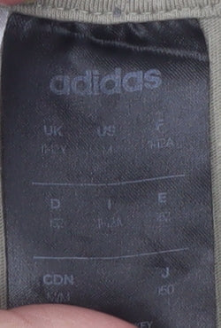 Brand and care label for Adidas boys’ beige graphic logo t-shirt 13-14 years short sleeve cotton