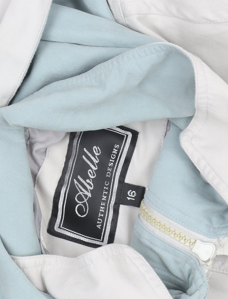 Brand and care label for Aberille unisex white hooded rain coat, size 16, mid-length cotton blend