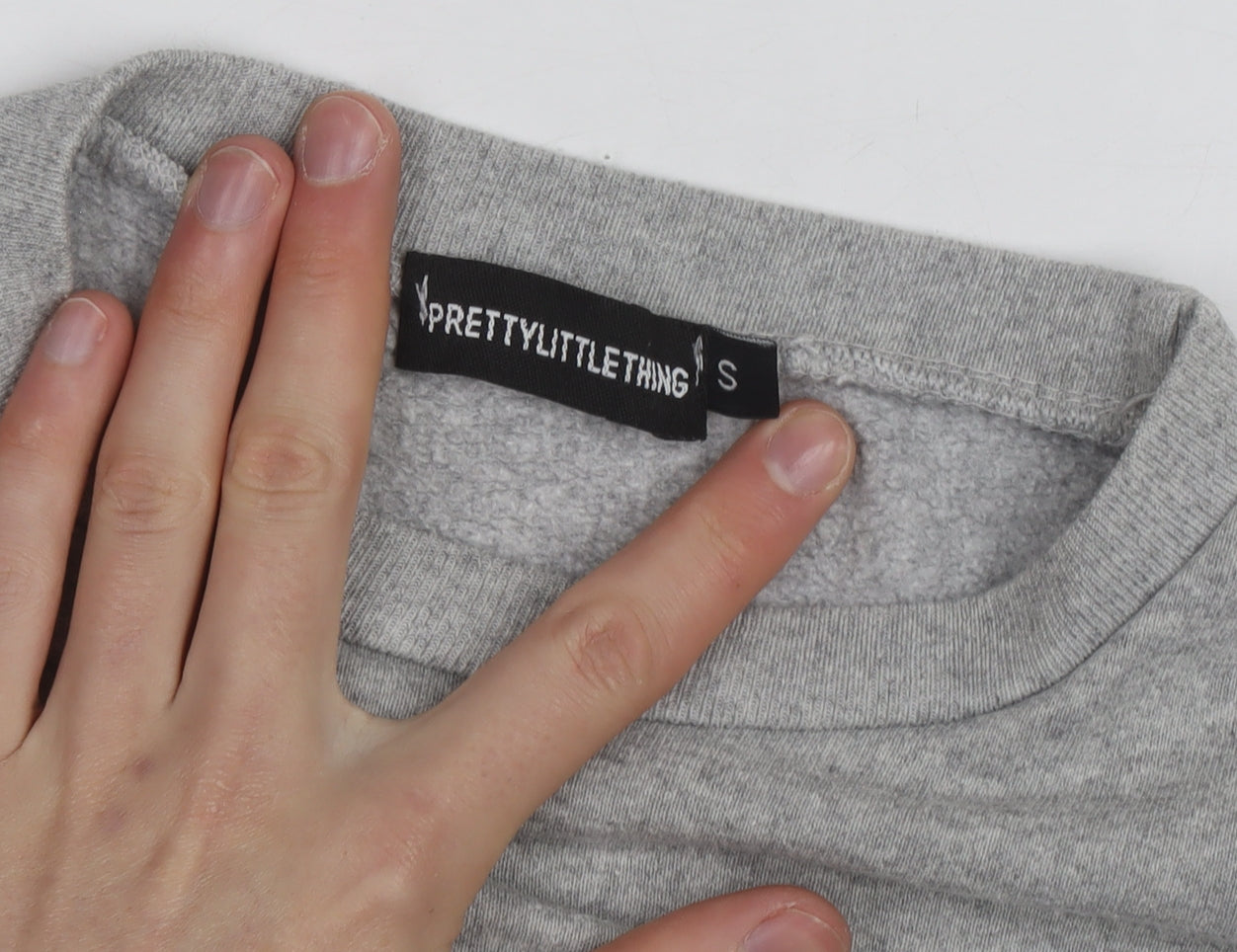 Brand and care label for PRETTYLITTLETHING Grey California West Coast Sweatshirt Small unisex
