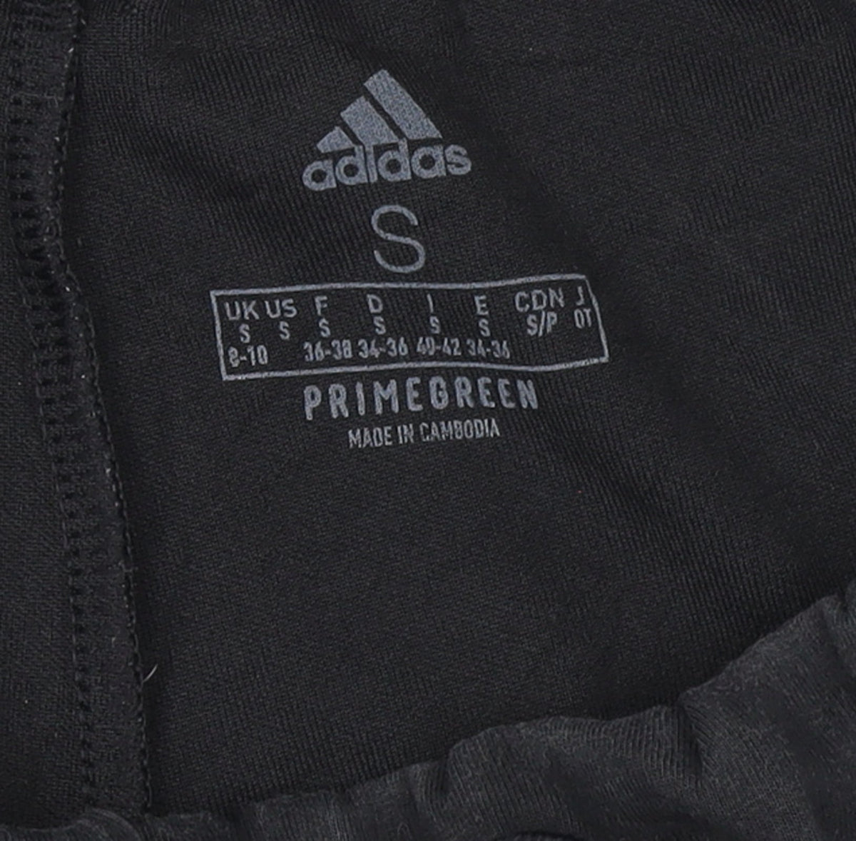 Brand and care label for Adidas women’s black jogger trousers, size S, regular fit