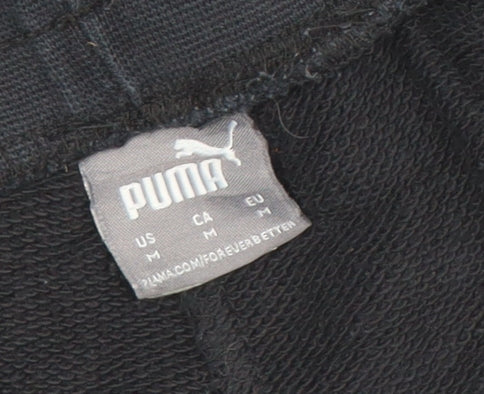 Brand and care label for Puma women’s black jogger trousers, size M, regular fit