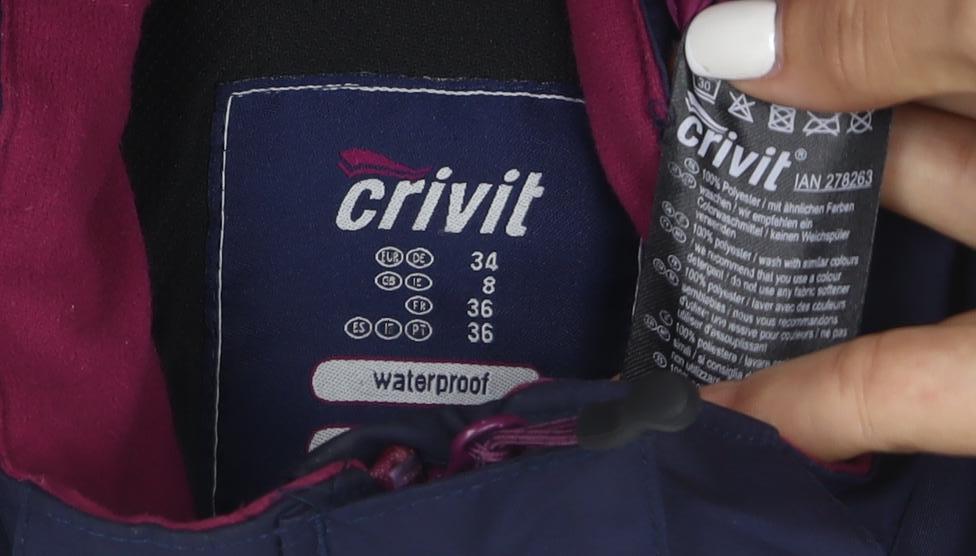 Brand and care label for Crivit women’s blue waterproof windproof full zip jacket, size UK 8