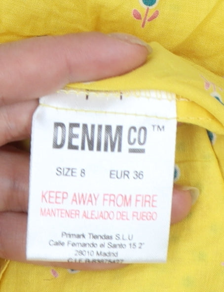 Brand and care label for Denim Co women’s yellow floral tunic blouse, size UK 8, short sleeve