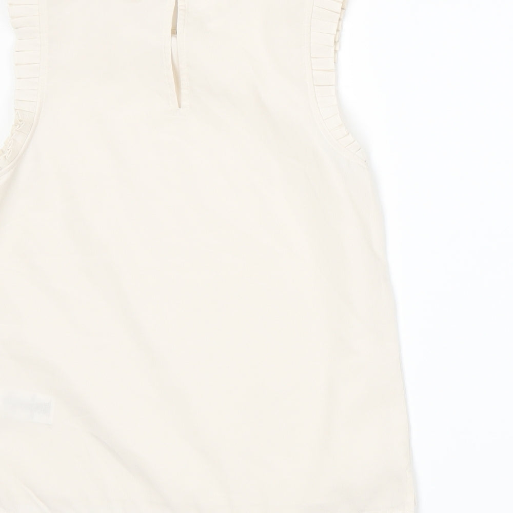 Brand and care label for Next girls’ beige basic blouse, size 9, years