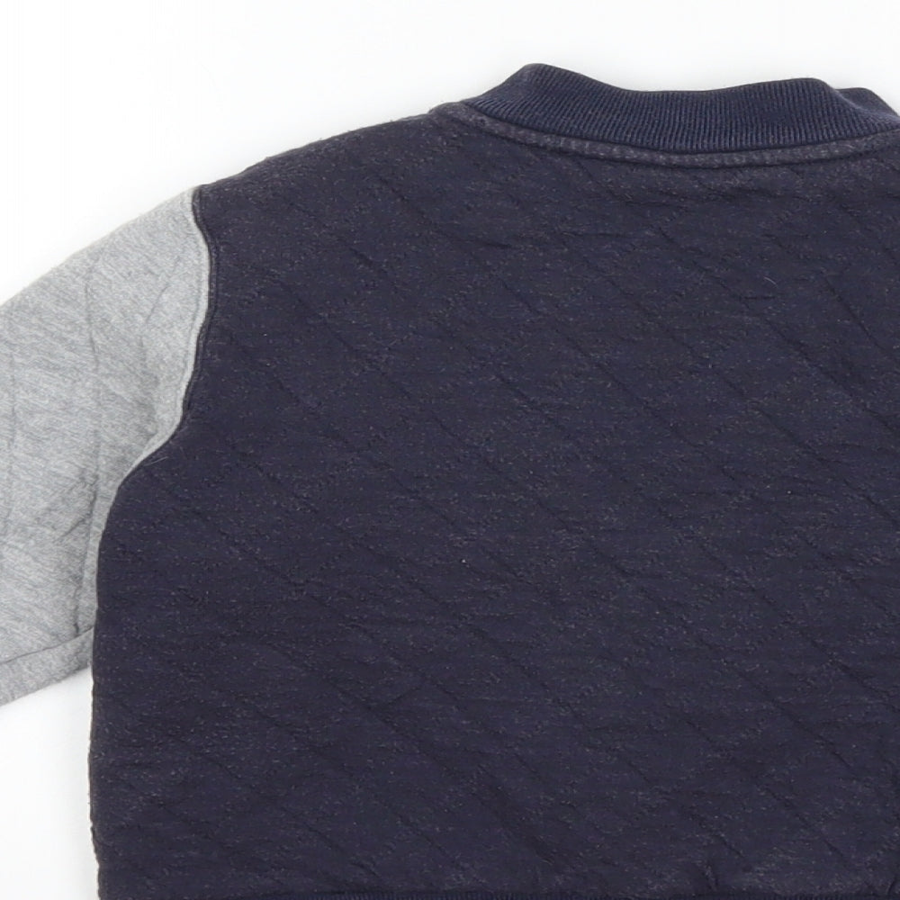 Brand and care label for Preworn boys’ blue jacket, size 3, years
