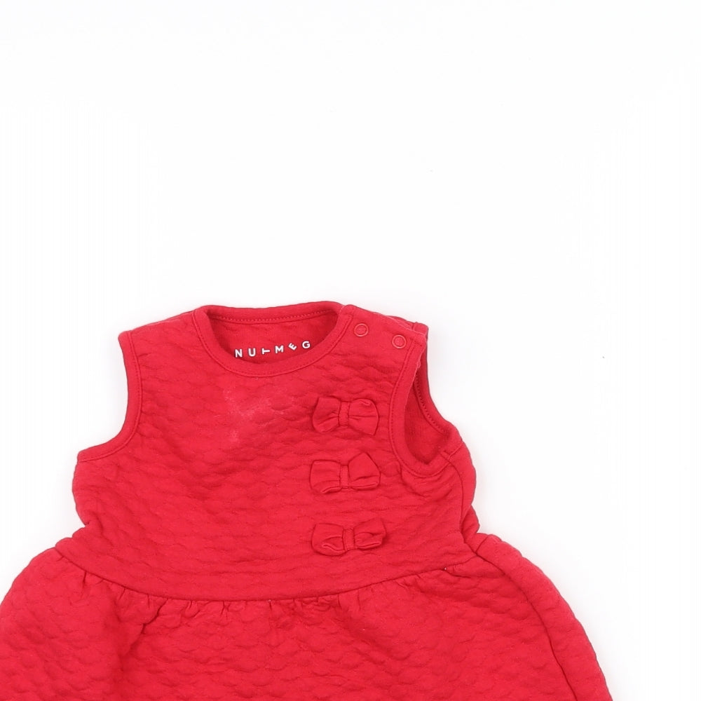 Close-up detail of Nutmeg Baby Red A-Line, size 3-6, Months