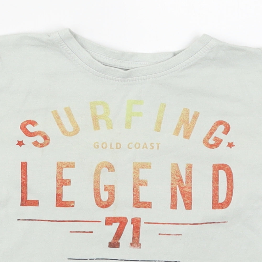 Close-up detail of Primark boys’ green basic t-shirt, size 3-4, years - surfing legend