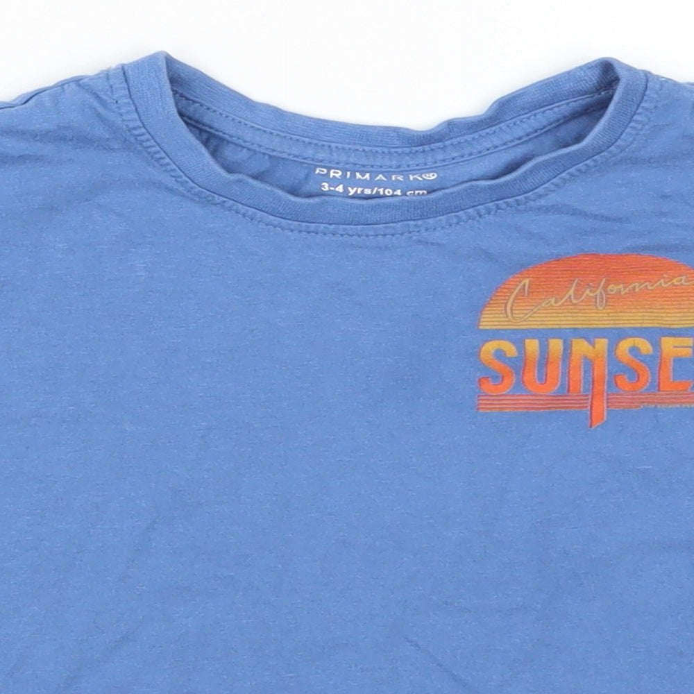Close-up detail of Primark boys’ blue basic t-shirt, size 3-4, years - california sunset