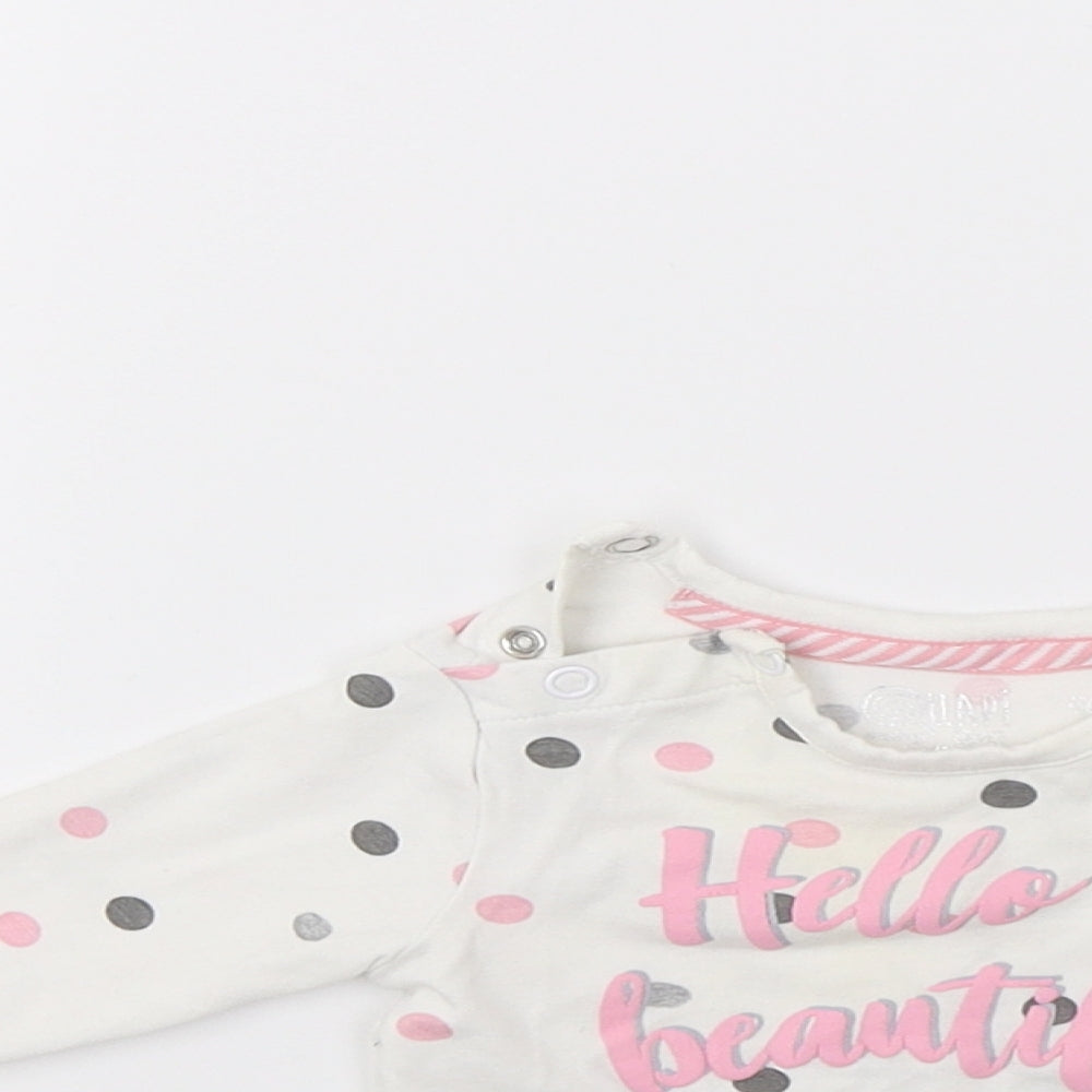 Close-up detail of Quapi girls’ white polka dot jumper, size 0-3, months - hello beautiful