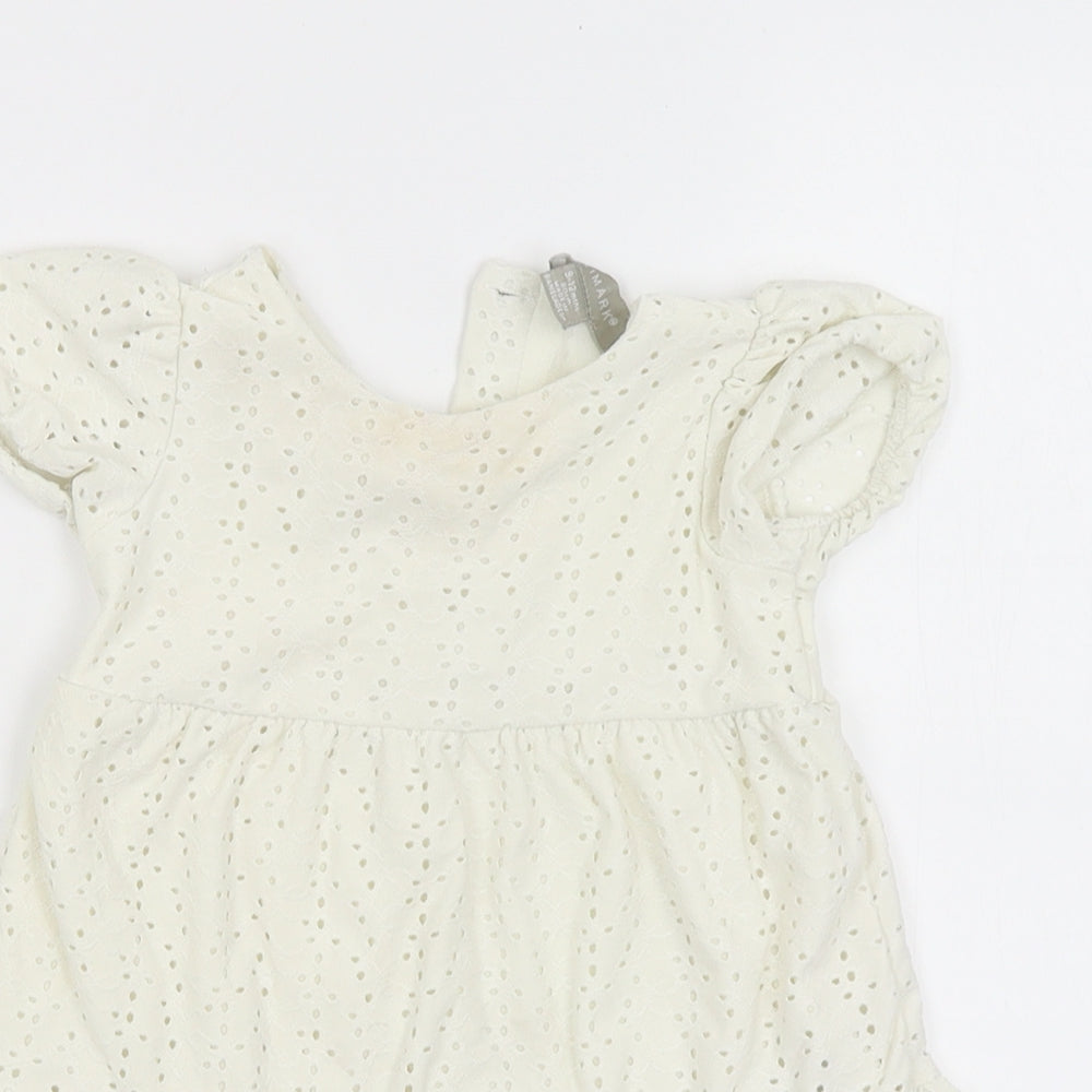 Close-up detail of Primark girls’ yellow shift, size 9-12, months
