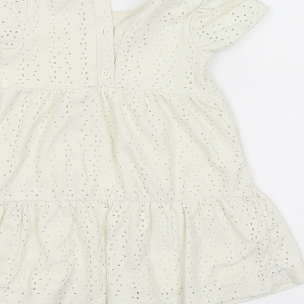 Brand and care label for Primark girls’ yellow shift, size 9-12, months