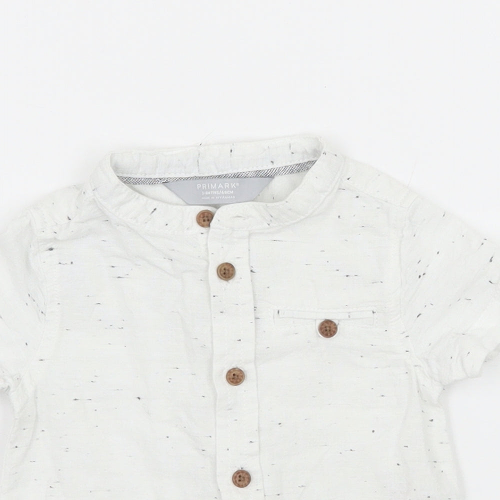 Close-up detail of Primark boys’ white basic button-up, size 3-6, months