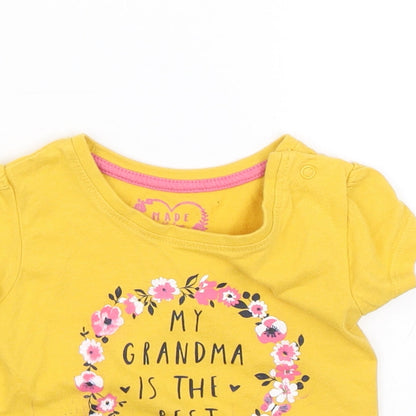 Close-up detail of Primark girls’ yellow basic t-shirt, size 6-9, months
