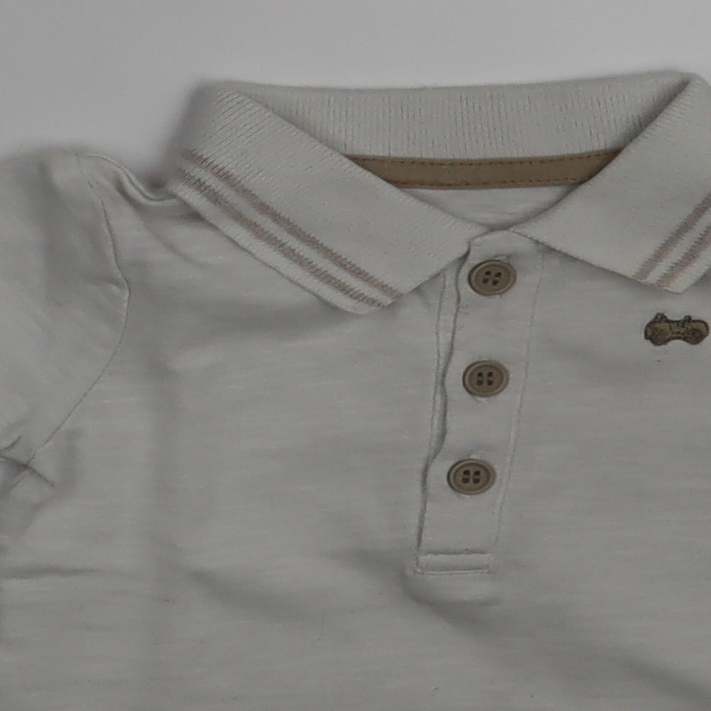 Close-up detail of George boys’ ivory pullover polo, size 0-3, months