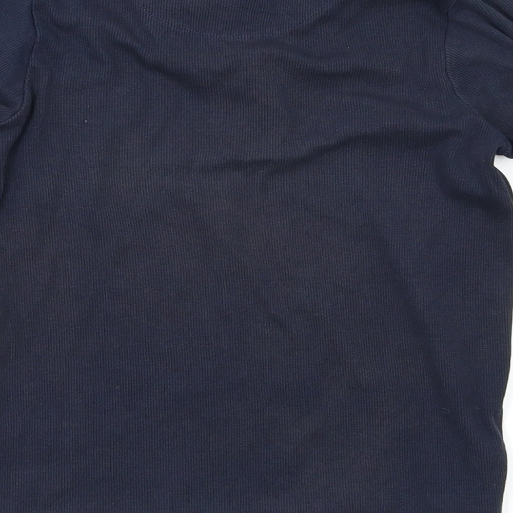 Brand and care label for Next girls’ blue basic blouse, size 7, years