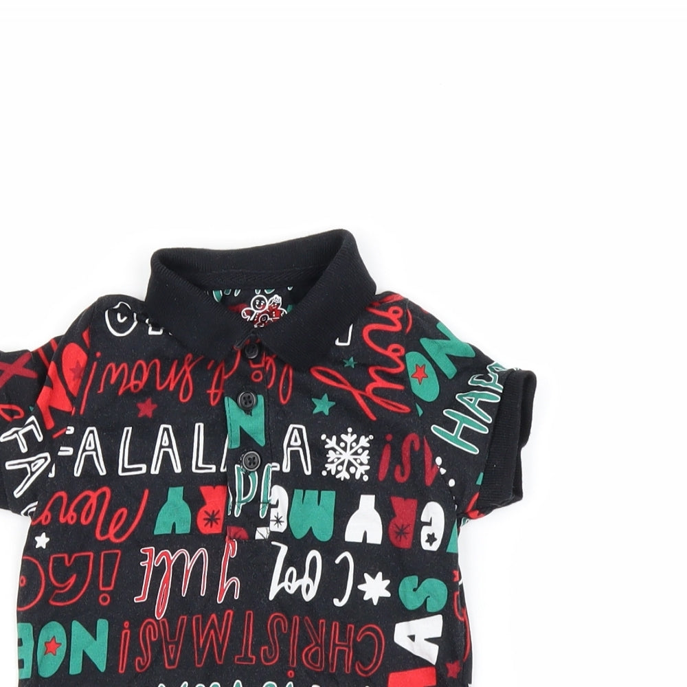 Close-up detail of Nutmeg boys’ black basic polo, size 12-18, months - chirstmas top