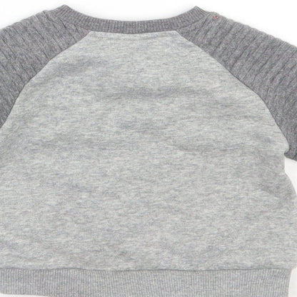 Brand and care label for Disney girls’ grey jumper, size 6-9, months