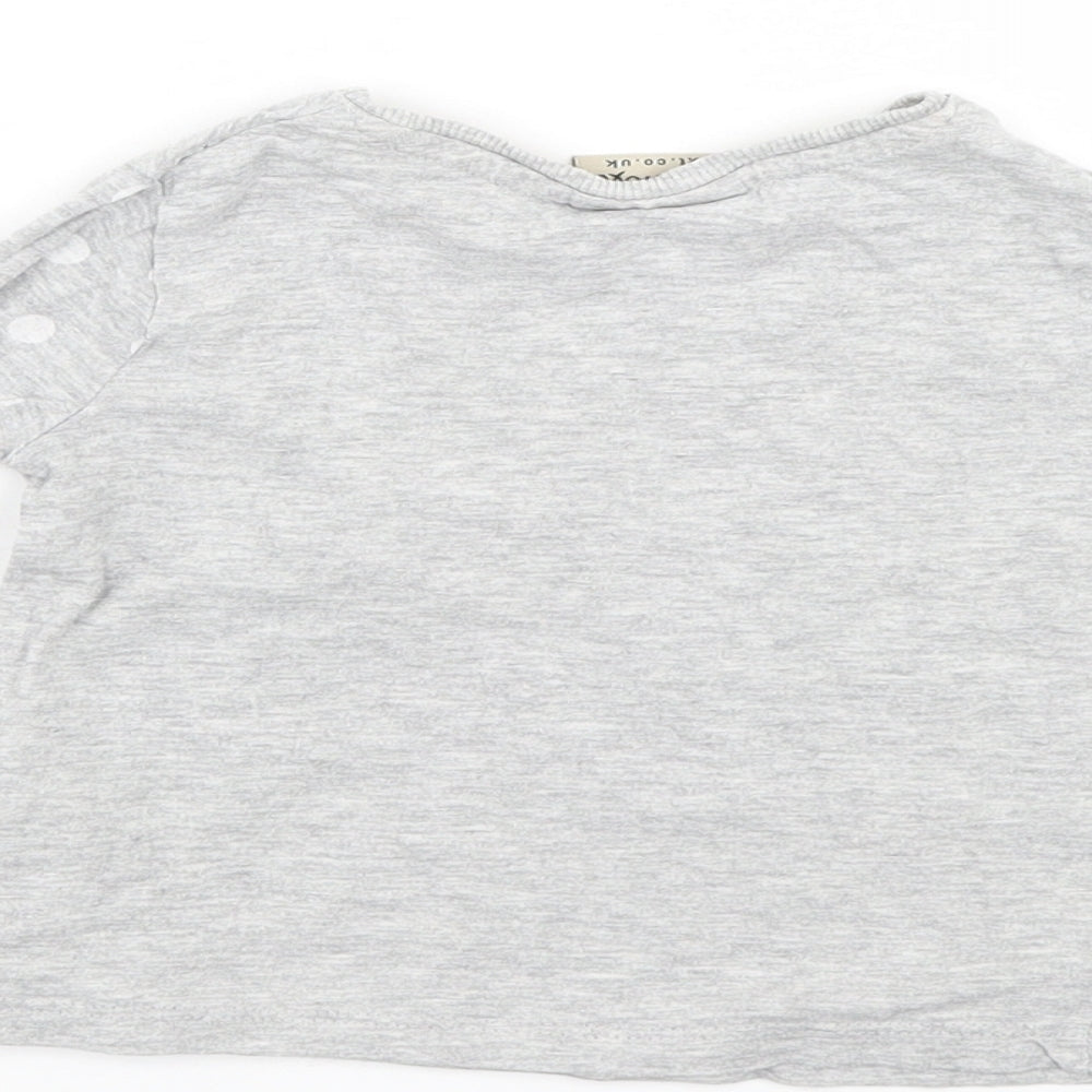 Brand and care label for Next girls’ grey jumper, size 9-12, months