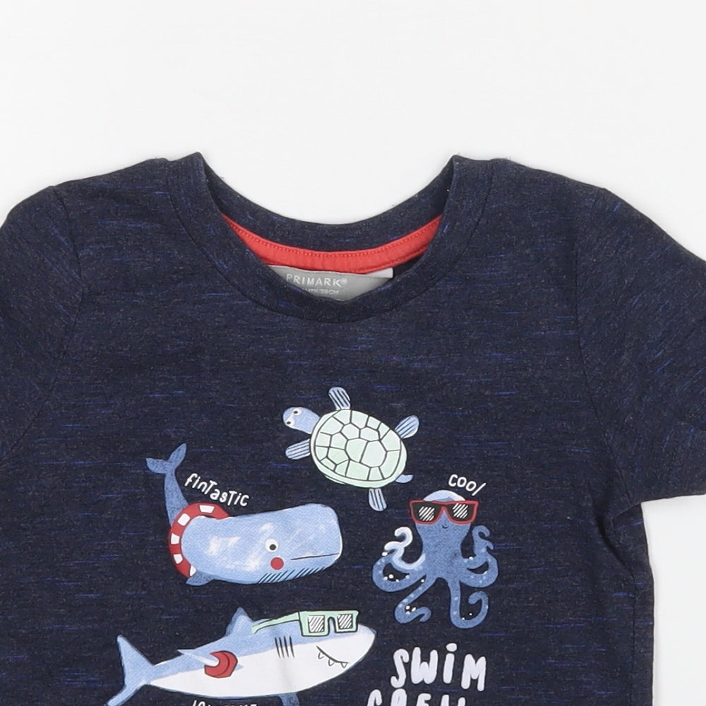 Close-up detail of Primark boys’ blue basic t-shirt, size 12-18, months - swim crew