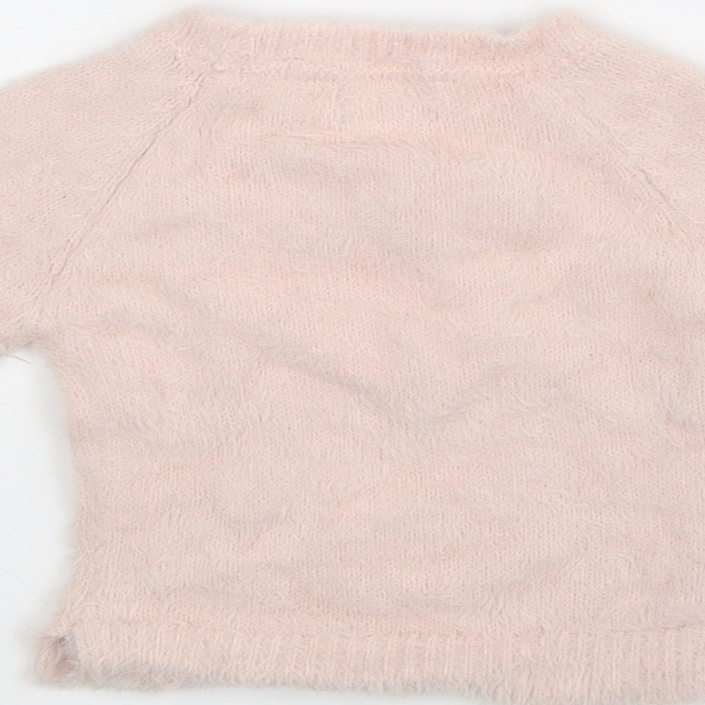 Brand and care label for Primark girls’ pink jumper, size 6-9, months
