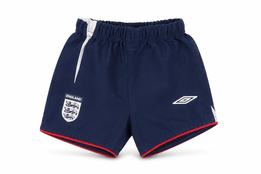 Front view of Umbro boys’ blue cropped trousers, size 6-9, months - england football shorts