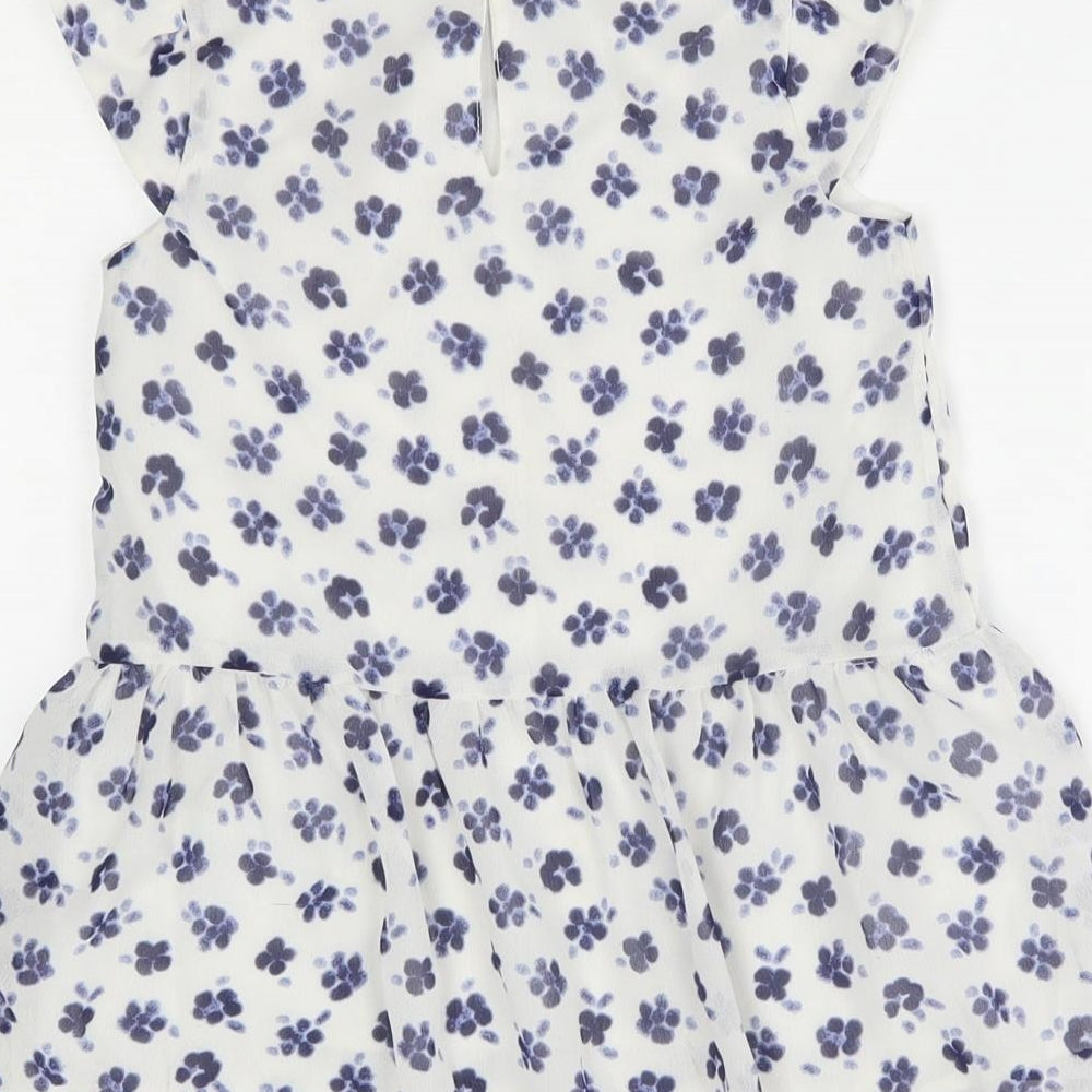 Brand and care label for George girls’ white floral basic blouse, size 8-9, years