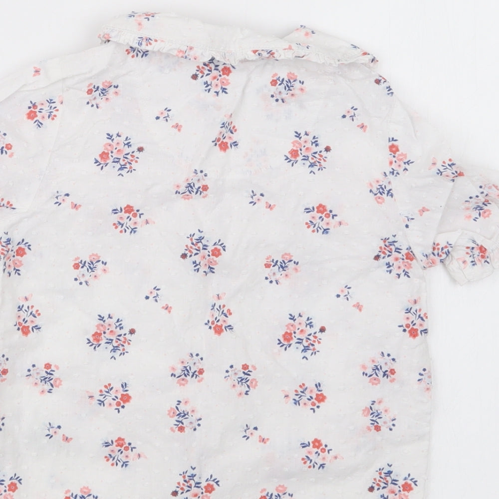 Brand and care label for Nutmeg girls’ white floral basic button-up, size 18-24, months