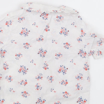 Brand and care label for Nutmeg girls’ white floral basic button-up, size 18-24, months