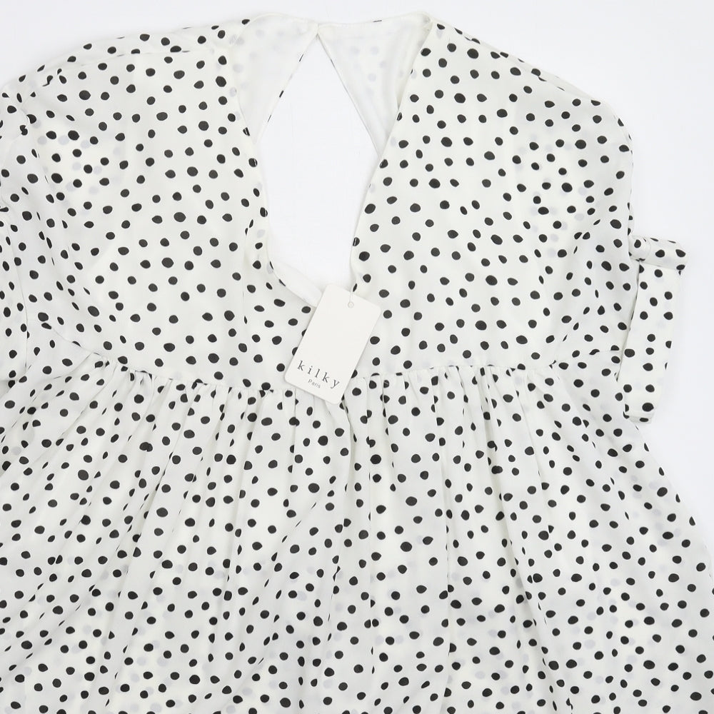 Close-up detail of Kilky women’s white polka dot mini, size M