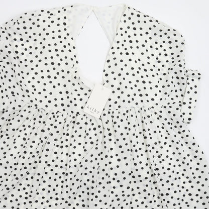 Close-up detail of Kilky women’s white polka dot mini, size M