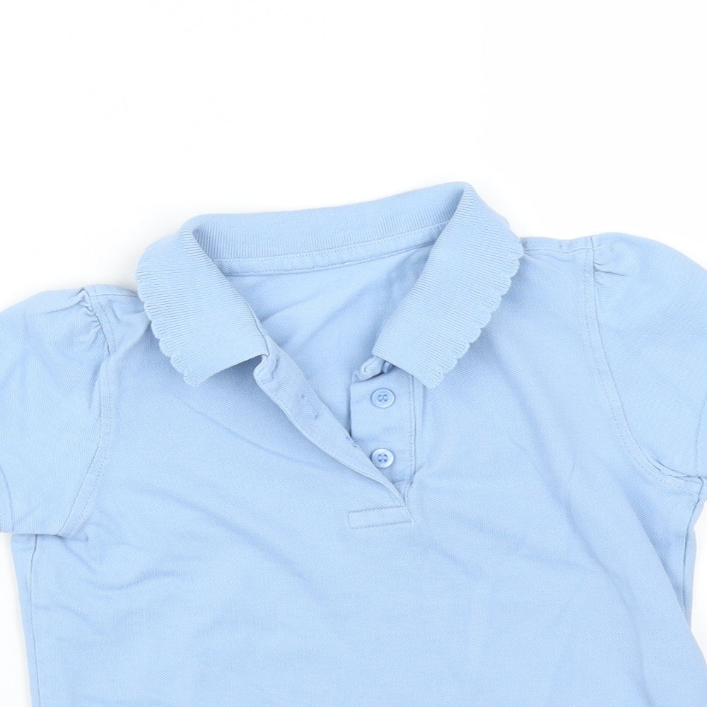 Close-up detail of girls’ blue basic polo