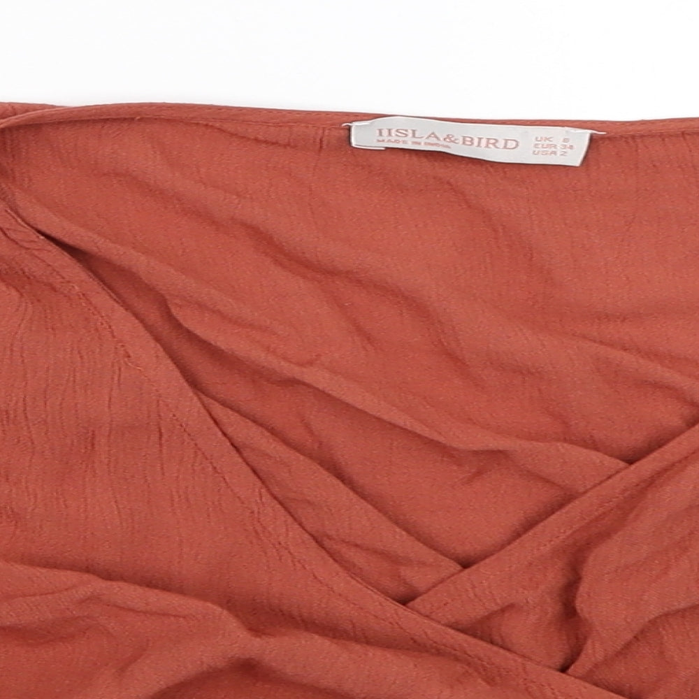 Close-up detail of Iisla & Bird women’s orange cropped blouse, size UK 6