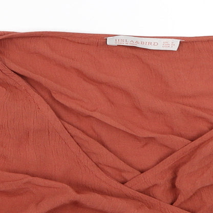 Close-up detail of Iisla & Bird women’s orange cropped blouse, size UK 6