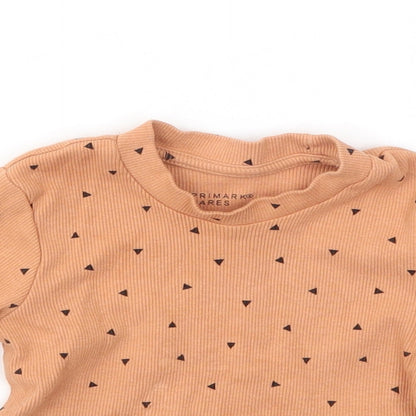 Close-up detail of Primark girls’ orange geometric basic t-shirt, size 9-12, months