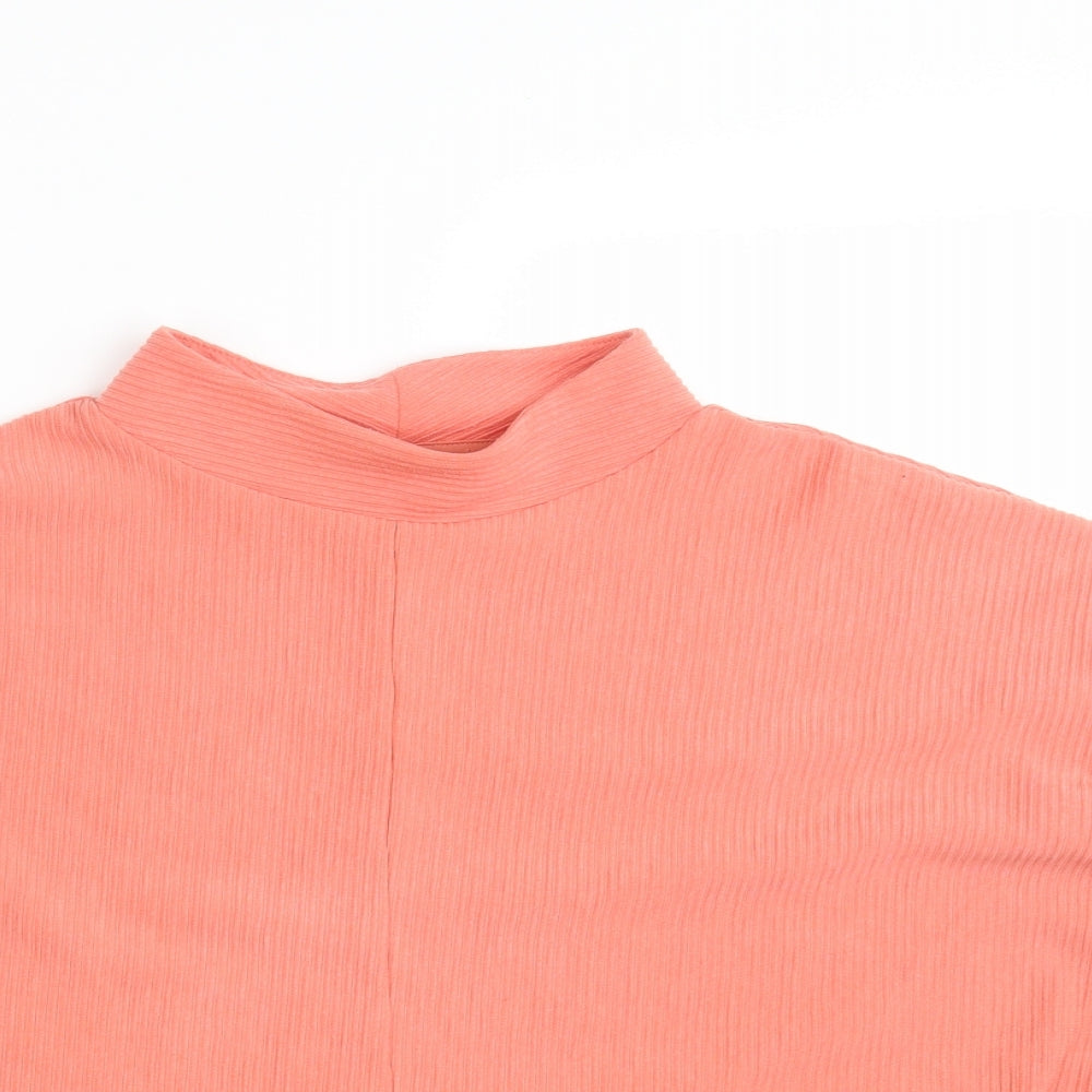 Close-up detail of Nutmeg women’s orange pullover sweatshirt, size UK 10