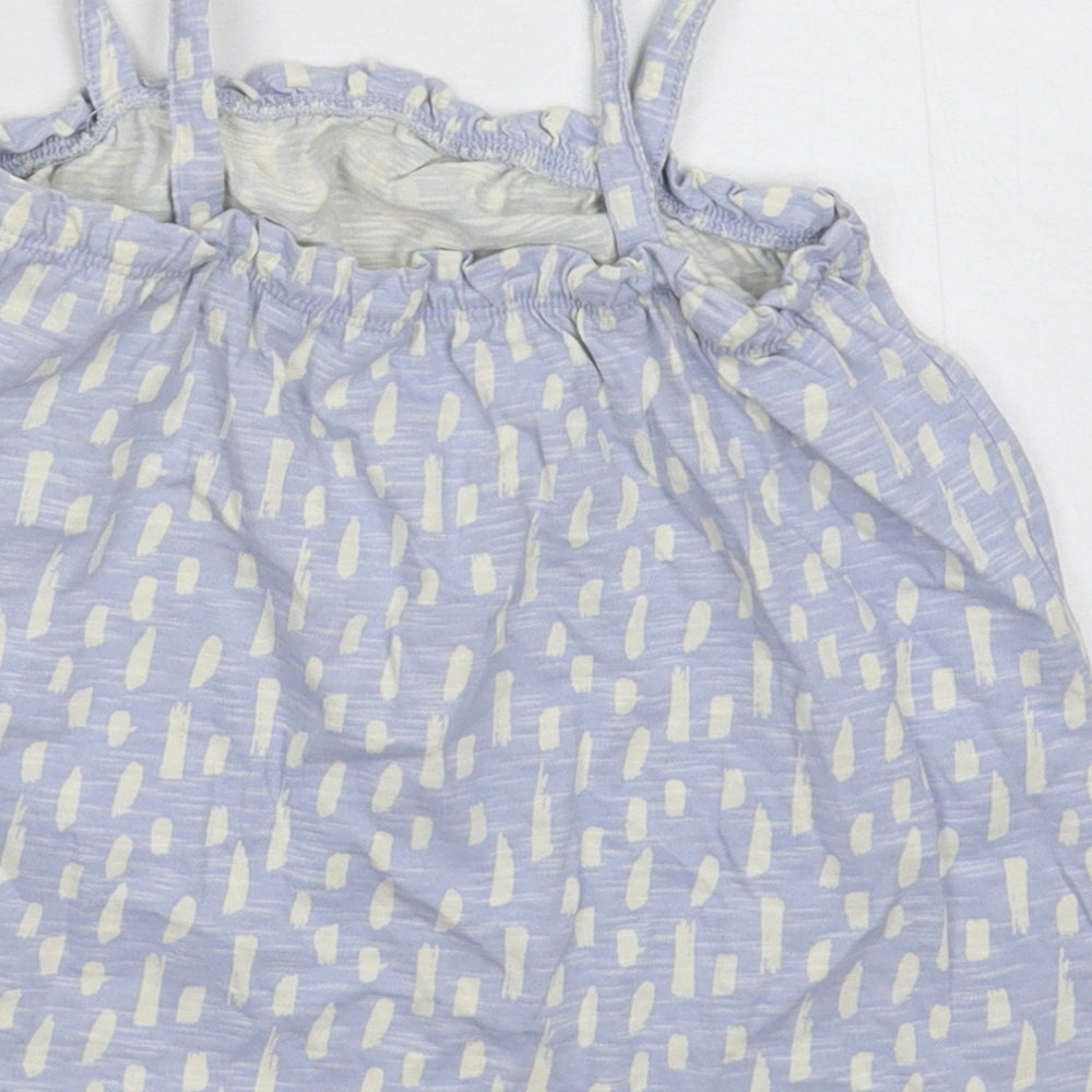 Brand and care label for Nutmeg girls’ blue basic tank, size 6-7, years
