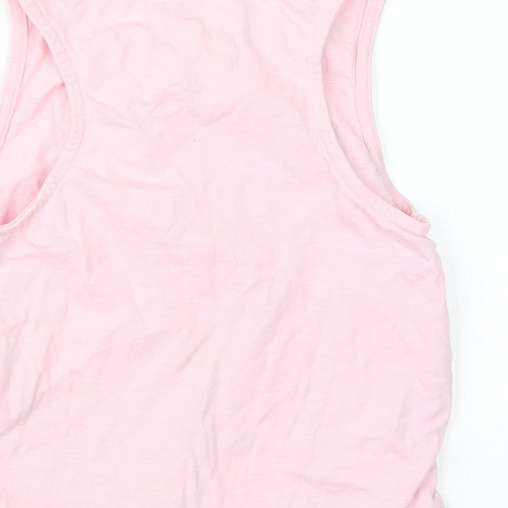 Brand and care label for Tu girls’ pink basic tank, size 7, years