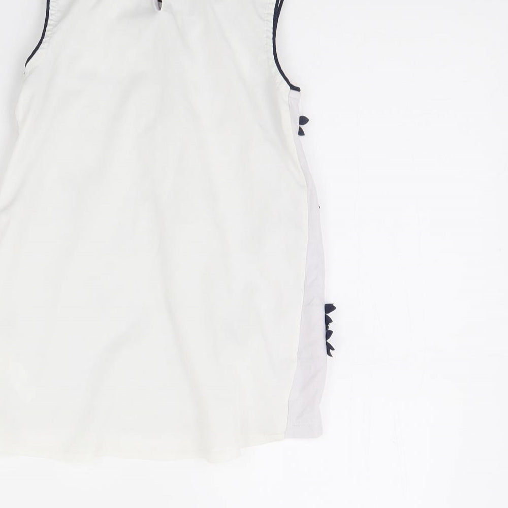 Brand and care label for George girls’ white basic tank, size 7, years