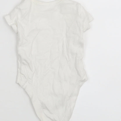 Brand and care label for Matalan boys’ white leotard one-piece size newborn