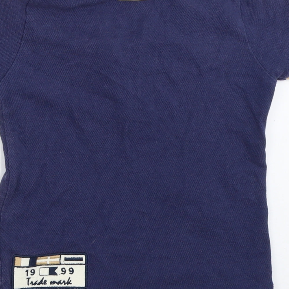 Brand and care label for Trasluz boys’ blue basic polo, size 3, years