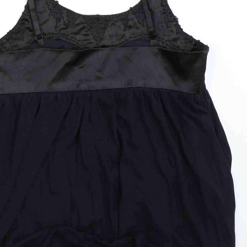 Brand and care label for Status Moda women’s black camisole blouse, size XS