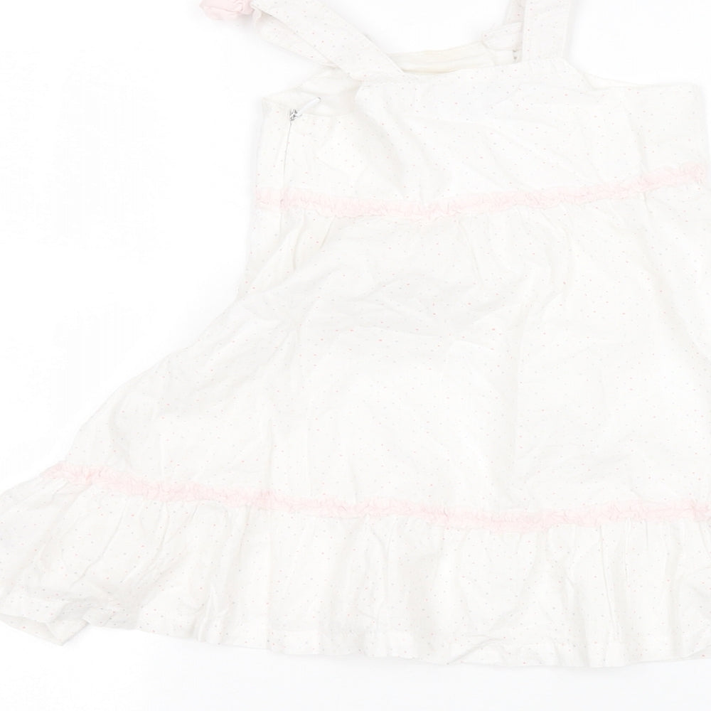 Brand and care label for bebe Baby White A-Line, size 12, Months